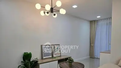 Modern living room with stylish chandelier and minimalist decor