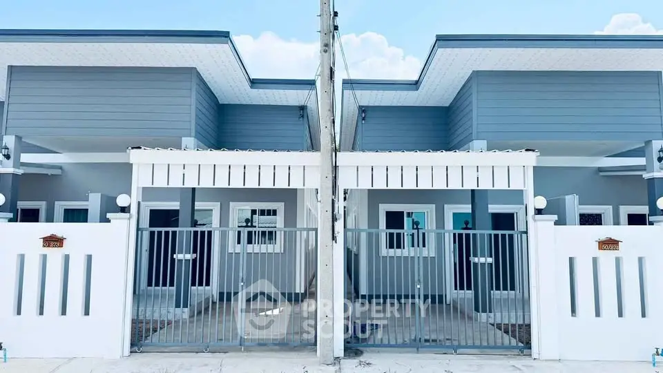 Modern duplex with sleek design and gated entrance, perfect for contemporary living.