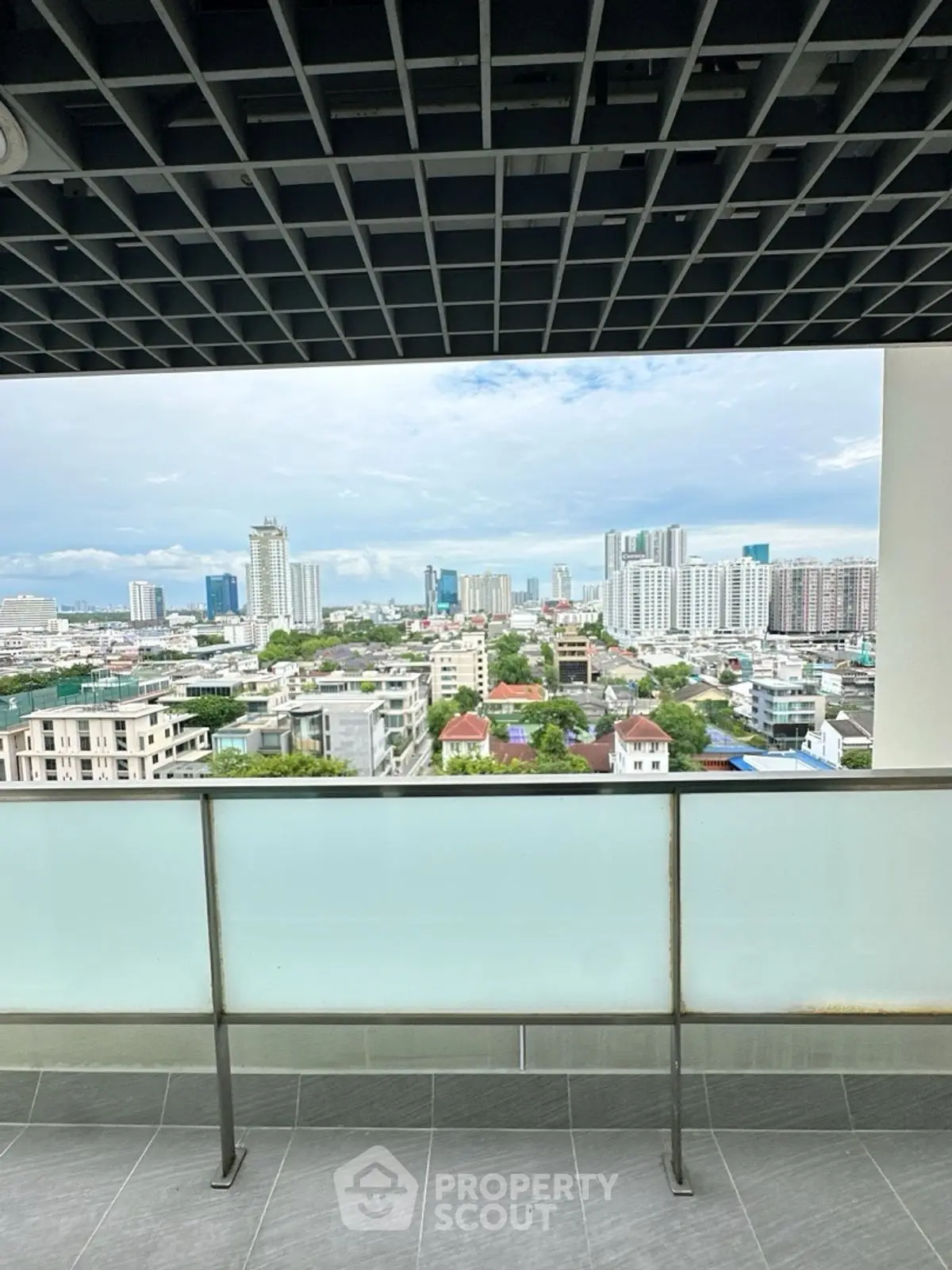 Stunning cityscape view from a modern balcony with sleek railing and urban skyline.