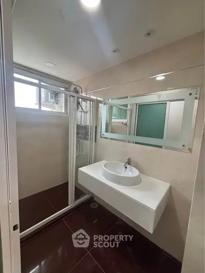 Modern bathroom with sleek sink and glass shower enclosure