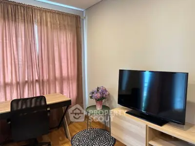 Cozy study area with desk, chair, and TV in a well-lit room with curtains.