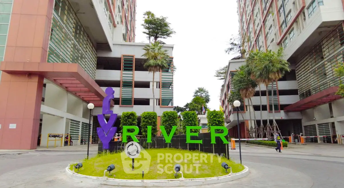 Modern urban building entrance with lush greenery and stylish architecture.