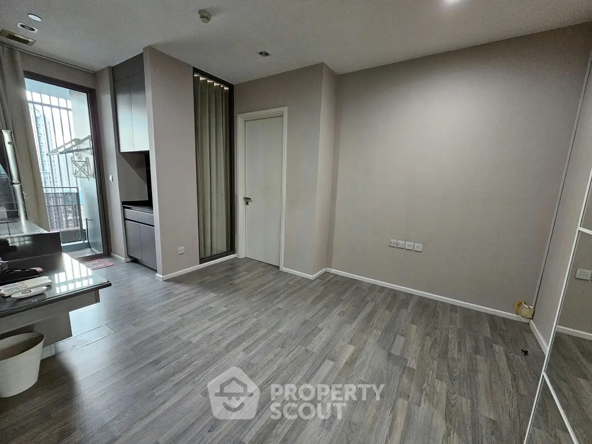 Spacious modern living room with sleek flooring and natural light