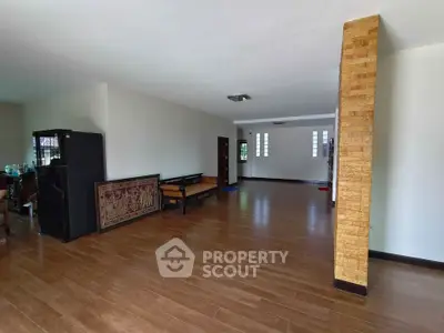 Spacious open living area with wooden flooring and modern design