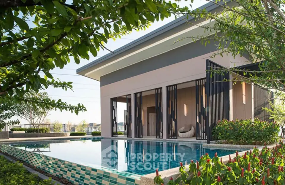 Modern house with sleek pool and lush garden in serene setting