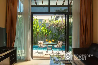 Luxurious living room seamlessly connects to a tranquil outdoor pool area with lush greenery, offering an oasis of relaxation and style.