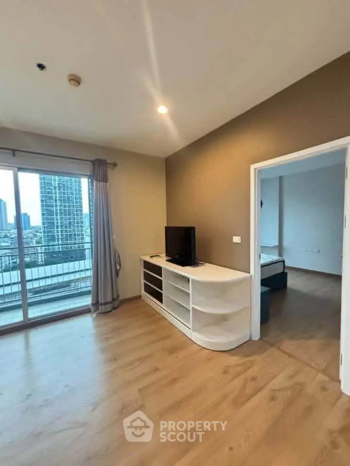 Spacious living room with balcony view in modern apartment