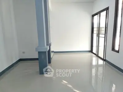 Spacious empty room with large windows and glossy tiled floor, perfect for customization.