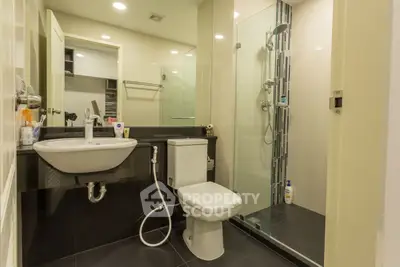 Modern bathroom with sleek fixtures and glass shower enclosure