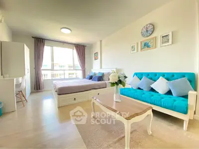 Bright and stylish studio apartment with modern decor and large window view.