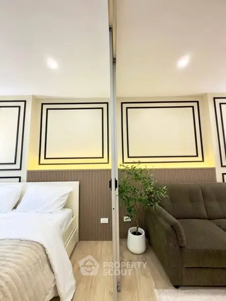 Modern bedroom with stylish decor and cozy seating area