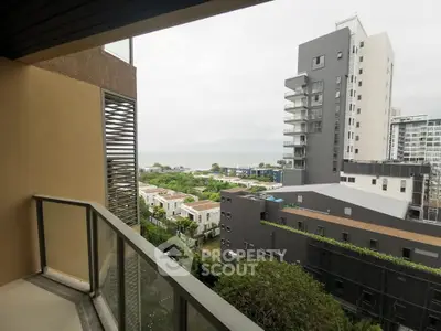 Modern balcony with stunning urban view and lush greenery