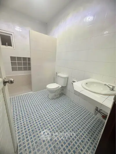 Spacious bathroom with modern fixtures and stylish tile flooring