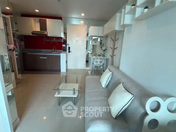 Modern living room with open kitchen and stylish decor in a cozy apartment.