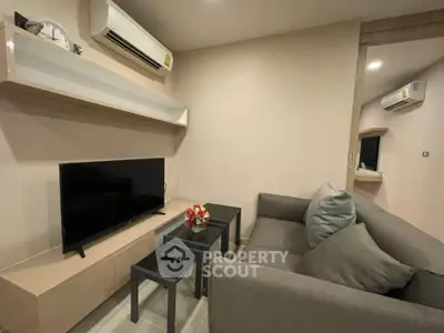 Modern living room with sleek furniture and wall-mounted TV, perfect for cozy relaxation.