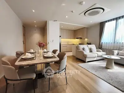 Modern open-plan living room with elegant dining area and cozy seating.