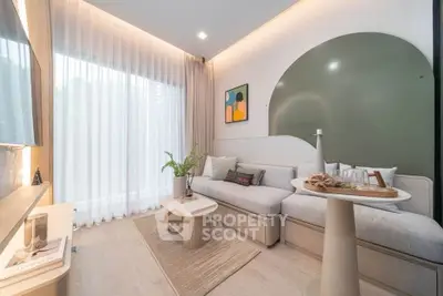 Modern living room with stylish decor, featuring a cozy sofa, elegant coffee table, and large window with sheer curtains.