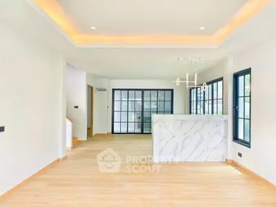 Spacious modern living room with elegant marble counter and large windows