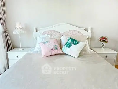 Elegant bedroom with stylish decor and cozy bedding in a bright, inviting space.