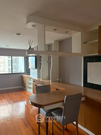Spacious open-plan living area with modern kitchen and hardwood floors