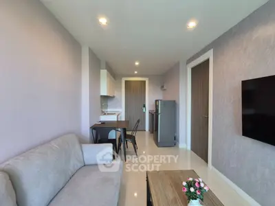 Modern living room with sleek furniture and open kitchen layout