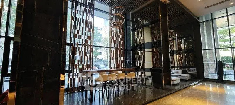 Luxurious modern building lobby with high ceilings and elegant seating area.