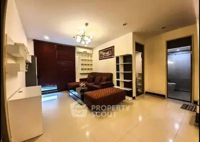 Spacious living room with modern furniture and elegant lighting in a cozy apartment.