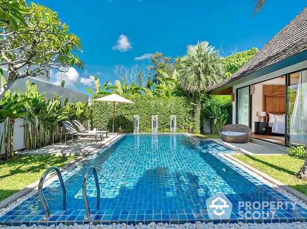 Luxurious villa with private pool and lush garden in tropical paradise setting.