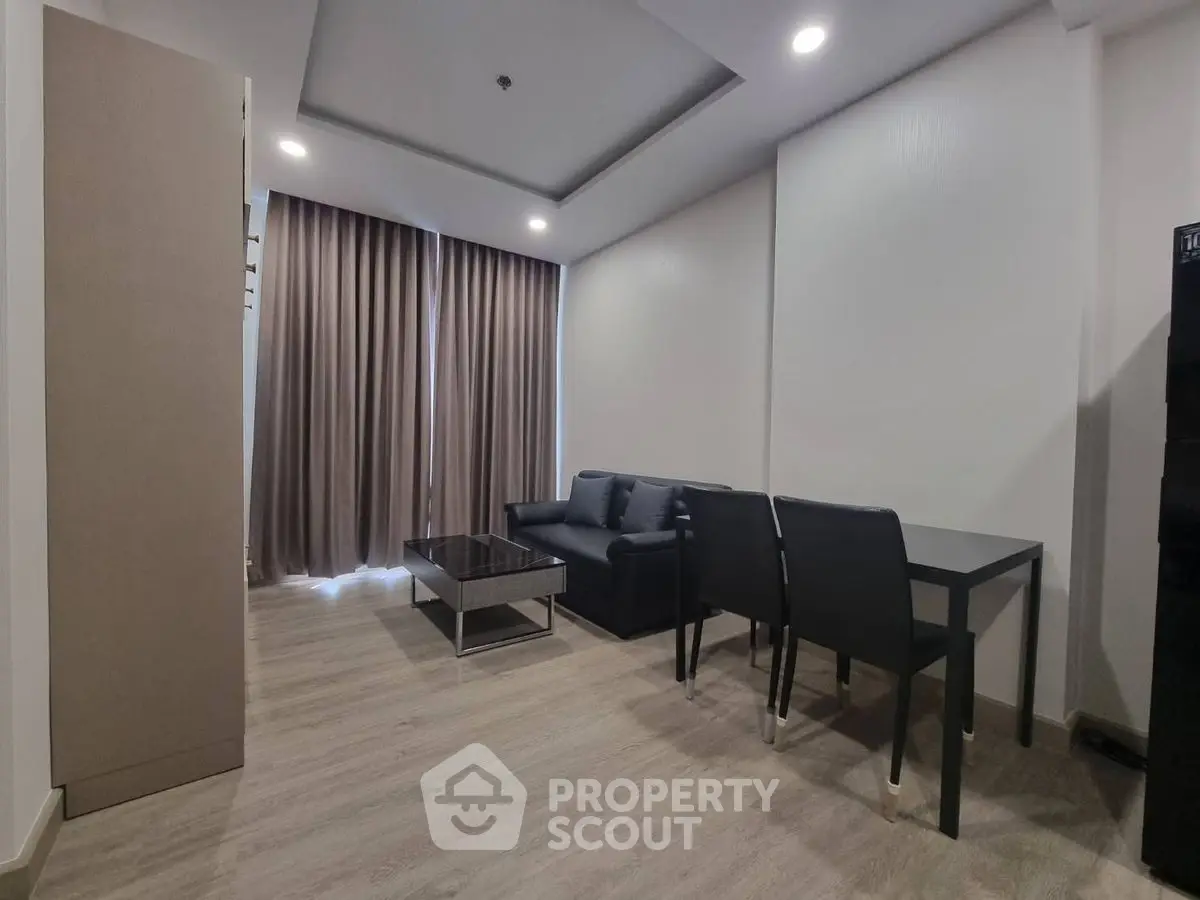 Modern living room with sleek furniture and elegant lighting, perfect for urban living.