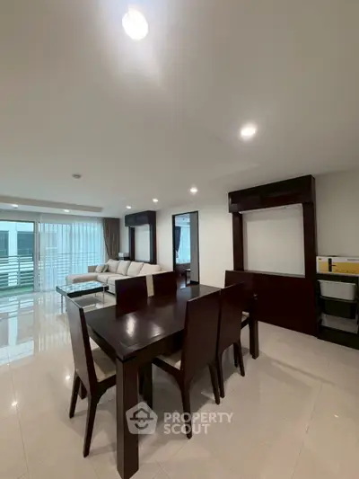 Spacious modern living room with dining area and elegant furniture in a bright apartment.