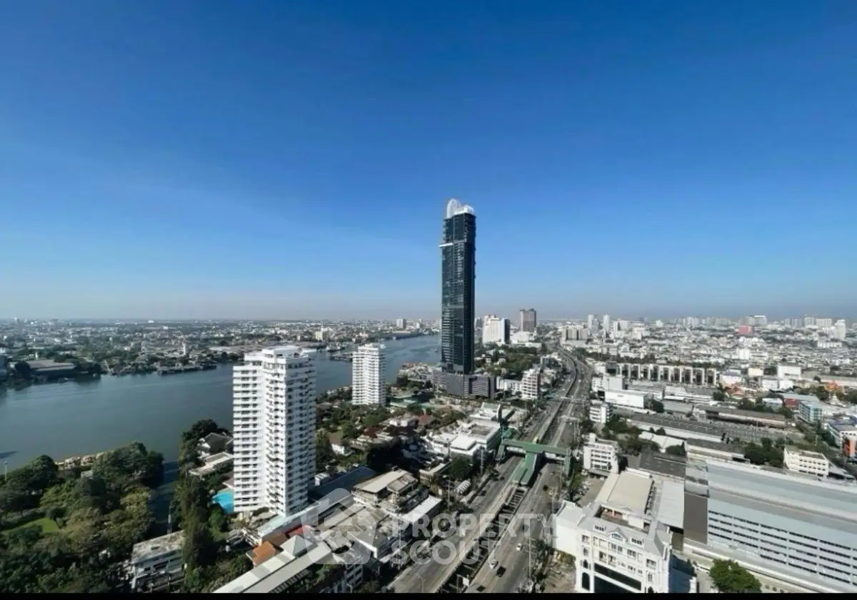 Stunning cityscape view with high-rise buildings and river, showcasing urban living at its finest.
