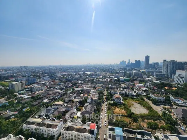 Stunning cityscape view from high-rise building showcasing urban skyline and residential areas.