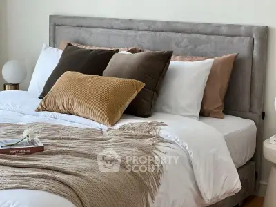Luxurious bedroom with plush pillows and cozy blanket, perfect for relaxation.