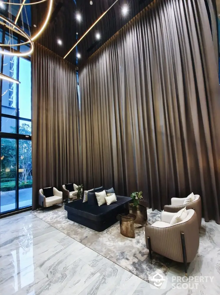 Luxurious high-ceiling lobby with elegant seating and floor-to-ceiling curtains