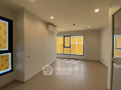 Spacious modern living room with large windows and sleek flooring