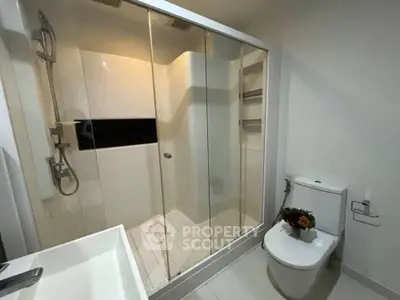 Modern bathroom with glass shower and sleek fixtures