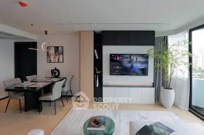 Modern living room with open layout, stylish dining area, and large TV, perfect for entertaining.