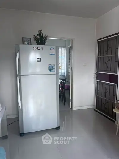 Modern kitchen with sleek refrigerator and dining area view