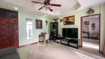 Spacious living room with modern decor and large TV unit