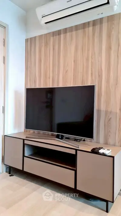 Modern living room with sleek TV unit and wood panel accent wall