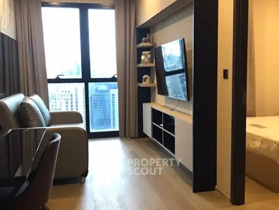 Modern living room with city view, sleek furniture, and wall-mounted TV in urban apartment.