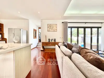 Spacious modern living room with elegant decor and large windows offering natural light.