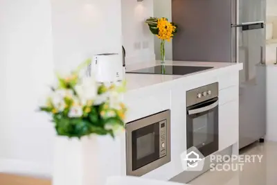 Modern kitchen with sleek appliances and elegant white cabinetry