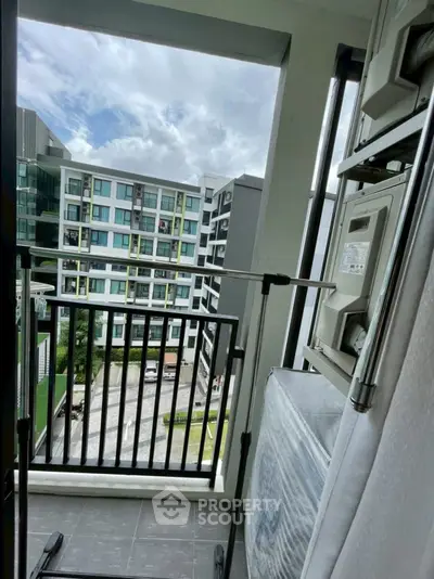 Modern apartment balcony with city view and laundry area