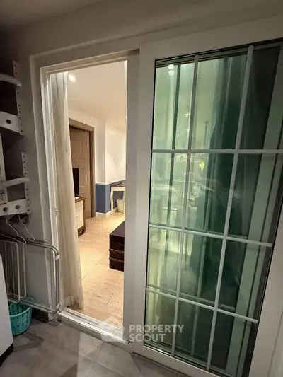 Cozy interior view through sliding glass door leading to a stylish living area.