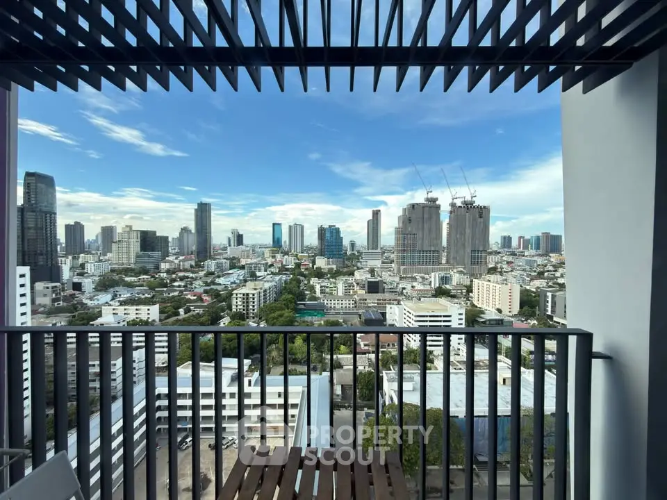 Stunning cityscape view from a modern balcony with skyline and construction cranes.