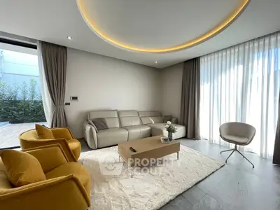 Modern living room with elegant furniture and large windows