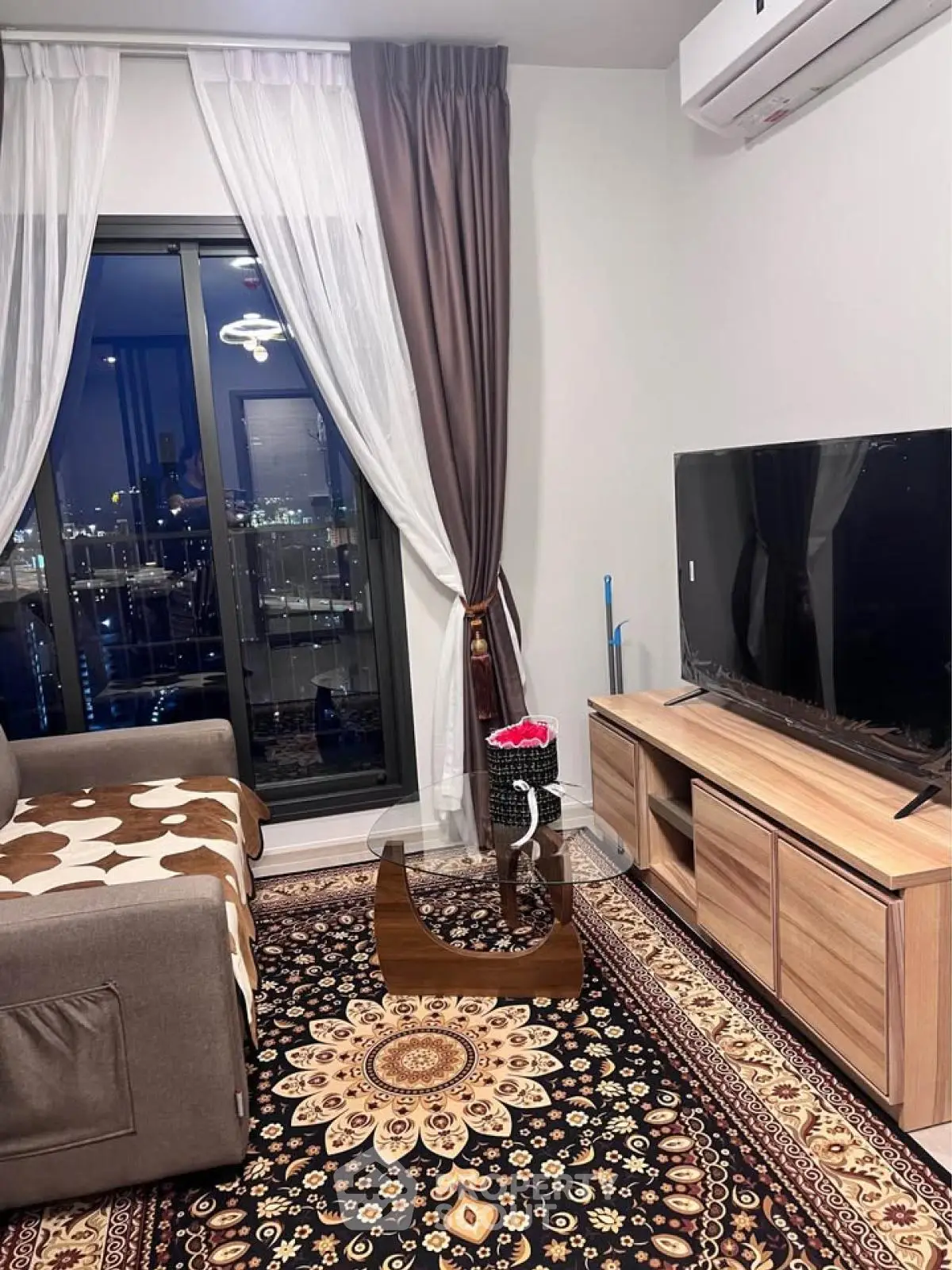 Cozy living room with city view, modern furniture, and elegant decor