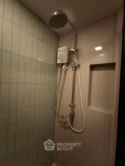 Modern bathroom shower with sleek tiles and water heater