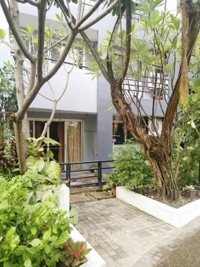 Charming residential entrance with lush greenery and modern facade